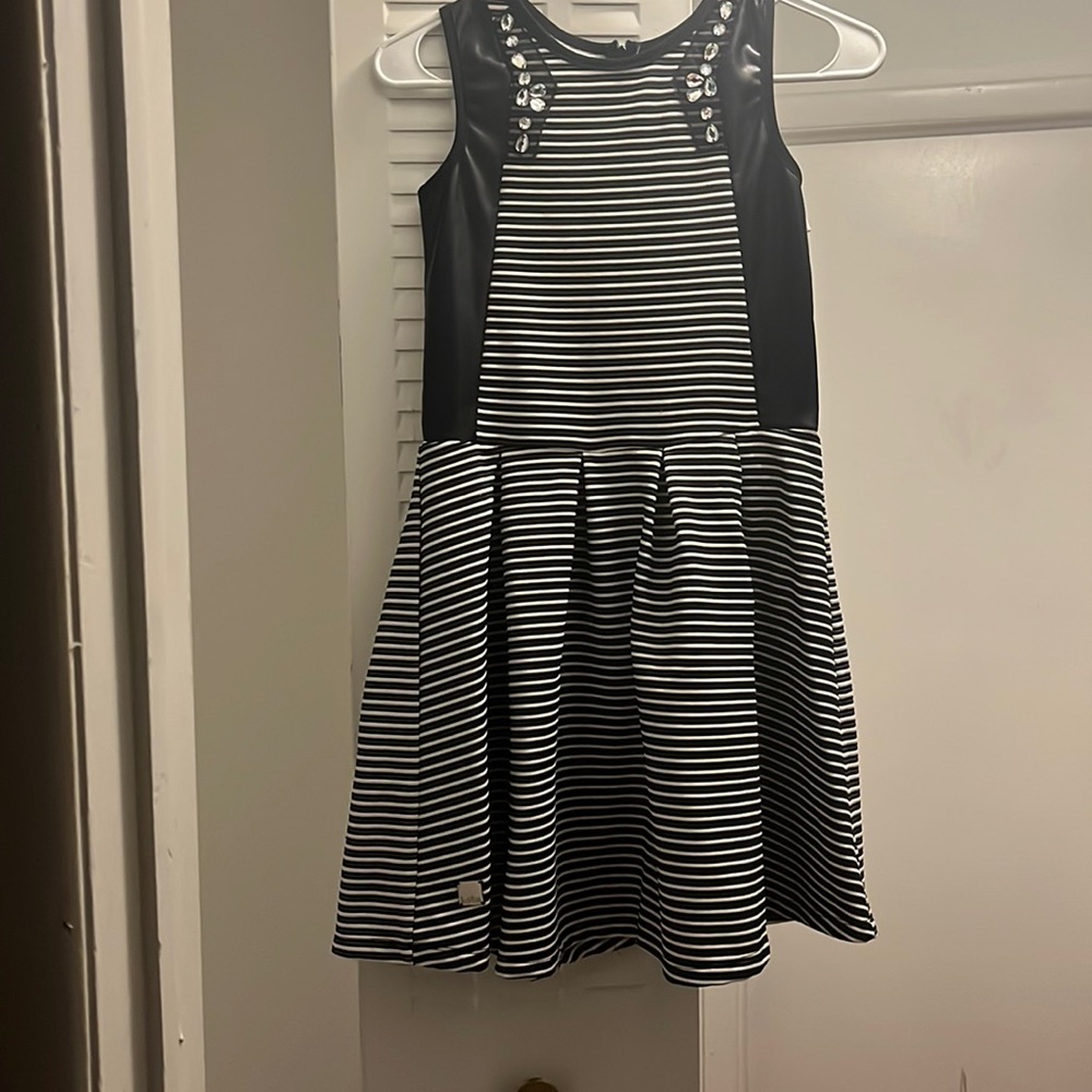 Cute dress with black leather like black material and bling. Very cute!